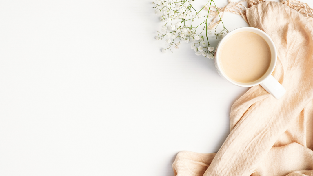 lightweight sheer scarf on white background beside cup of tea.