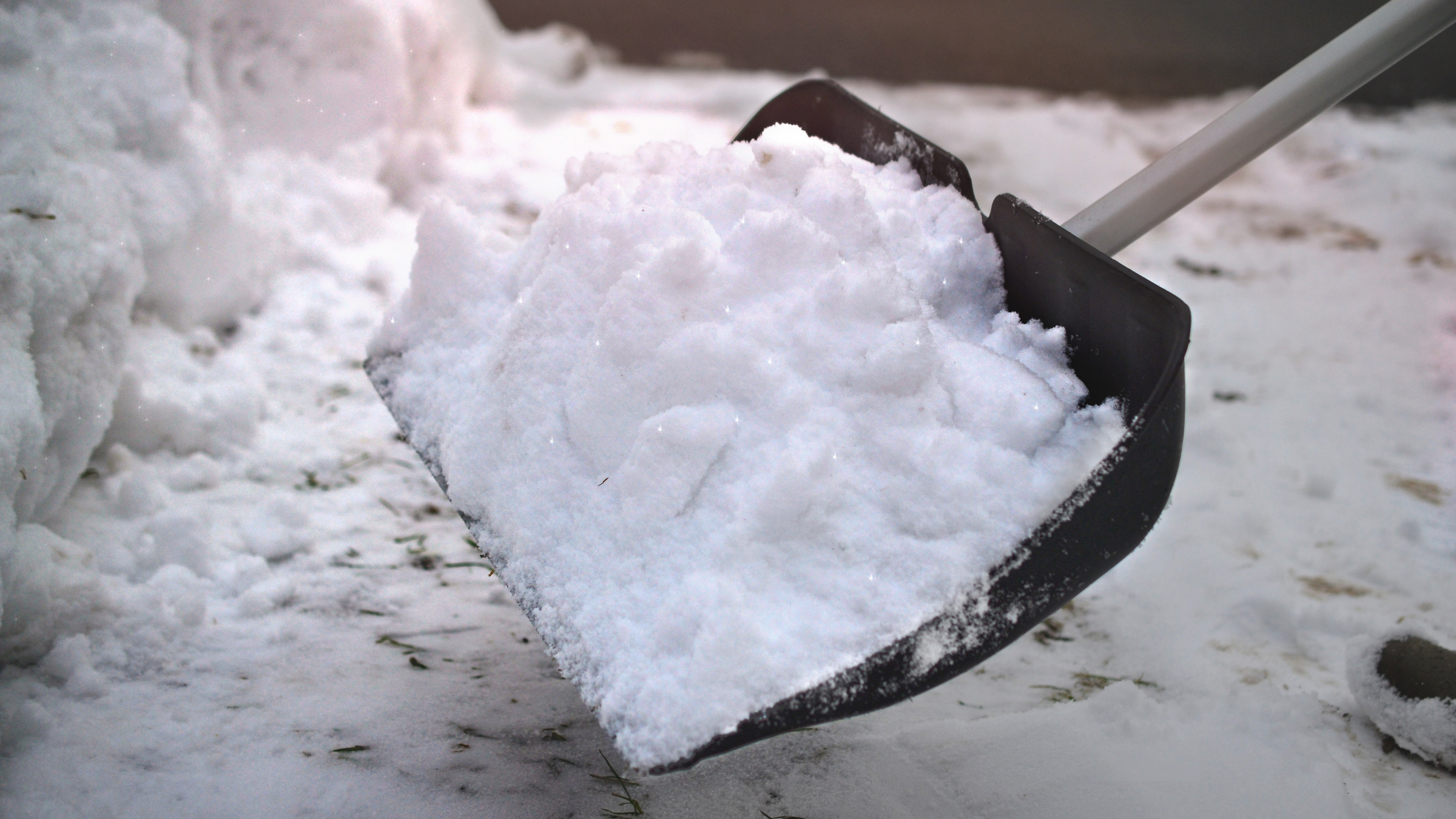 snow shovel with large pile of snow