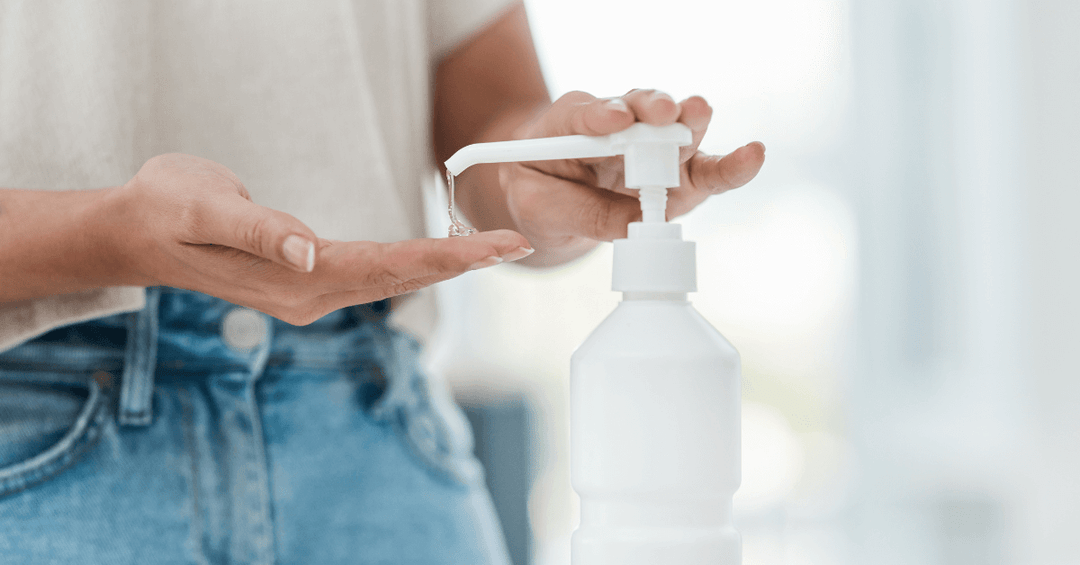 unidentified person using hand sanitiser to sanitize hands