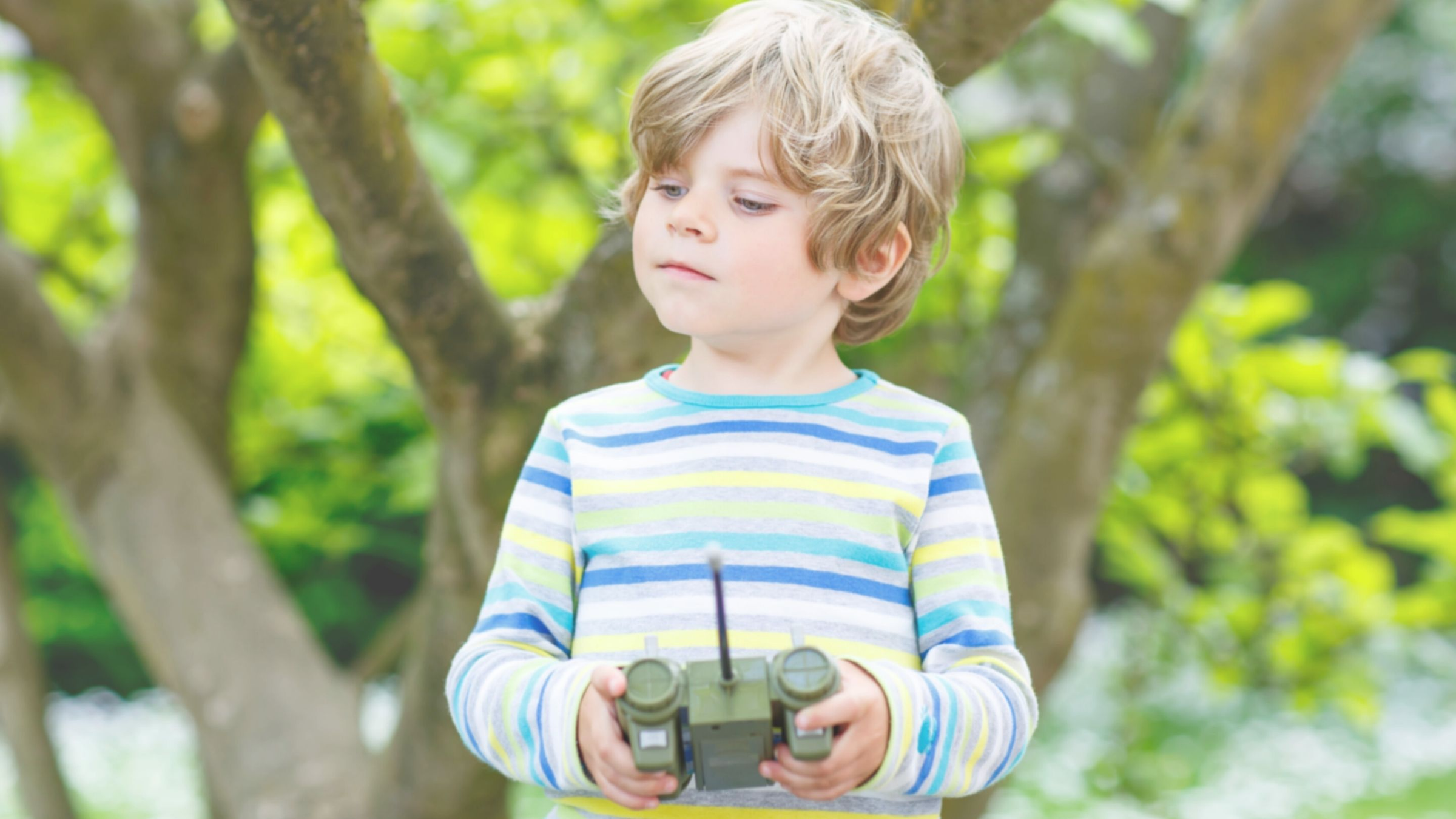 little boy operating his remote control toy