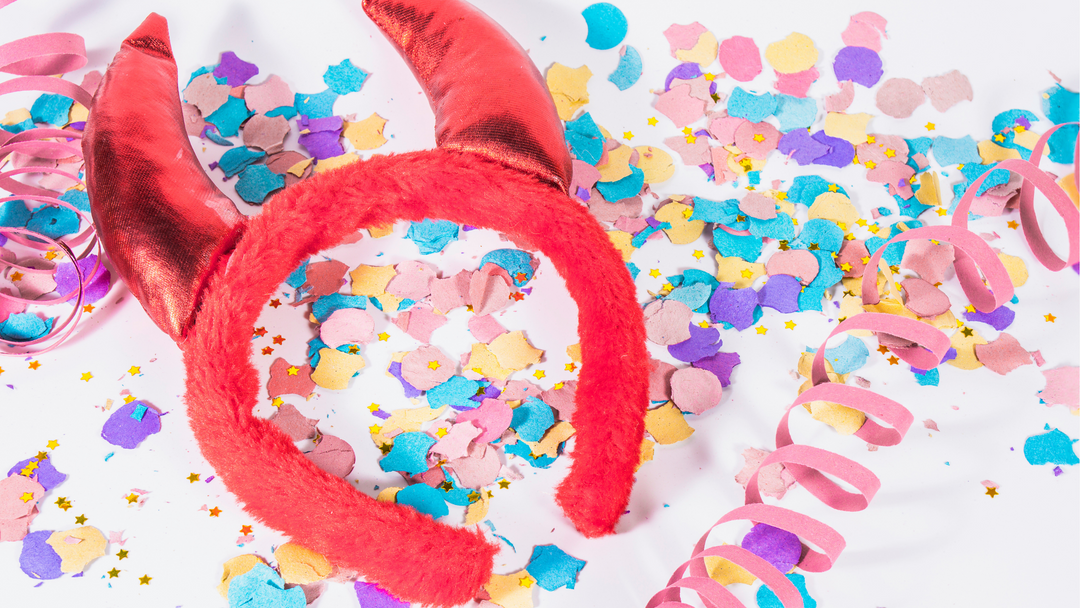 devil horn headband on a table of confetti