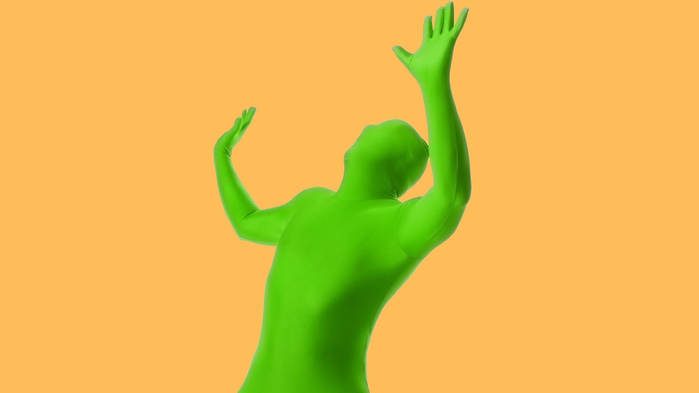 man wearing second skin tight green body suit on an orange background