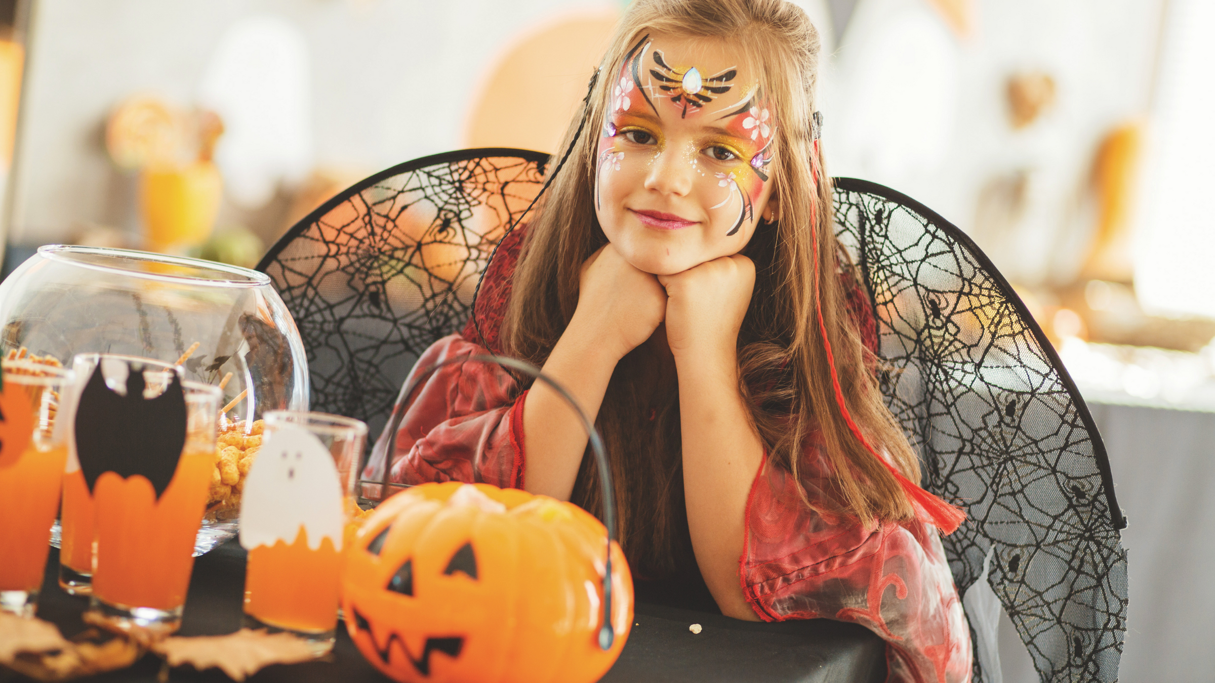 little girl dressed as a fairytale character with her face painted at a halloween party