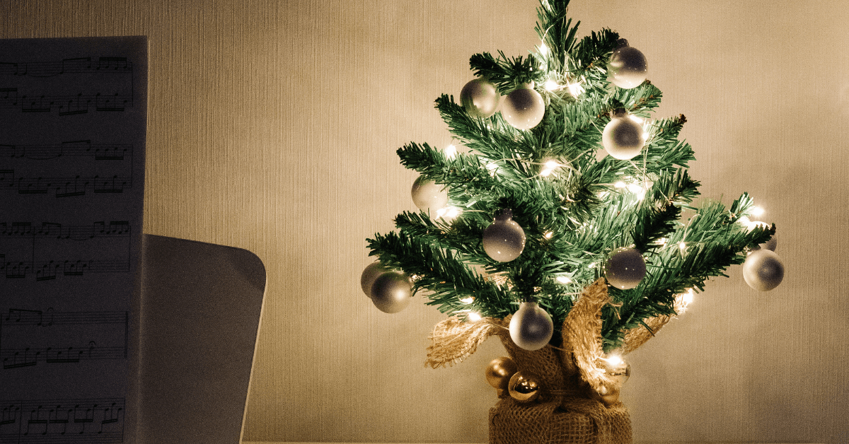 mini christmas tree with warm white led lights on shelf in living room