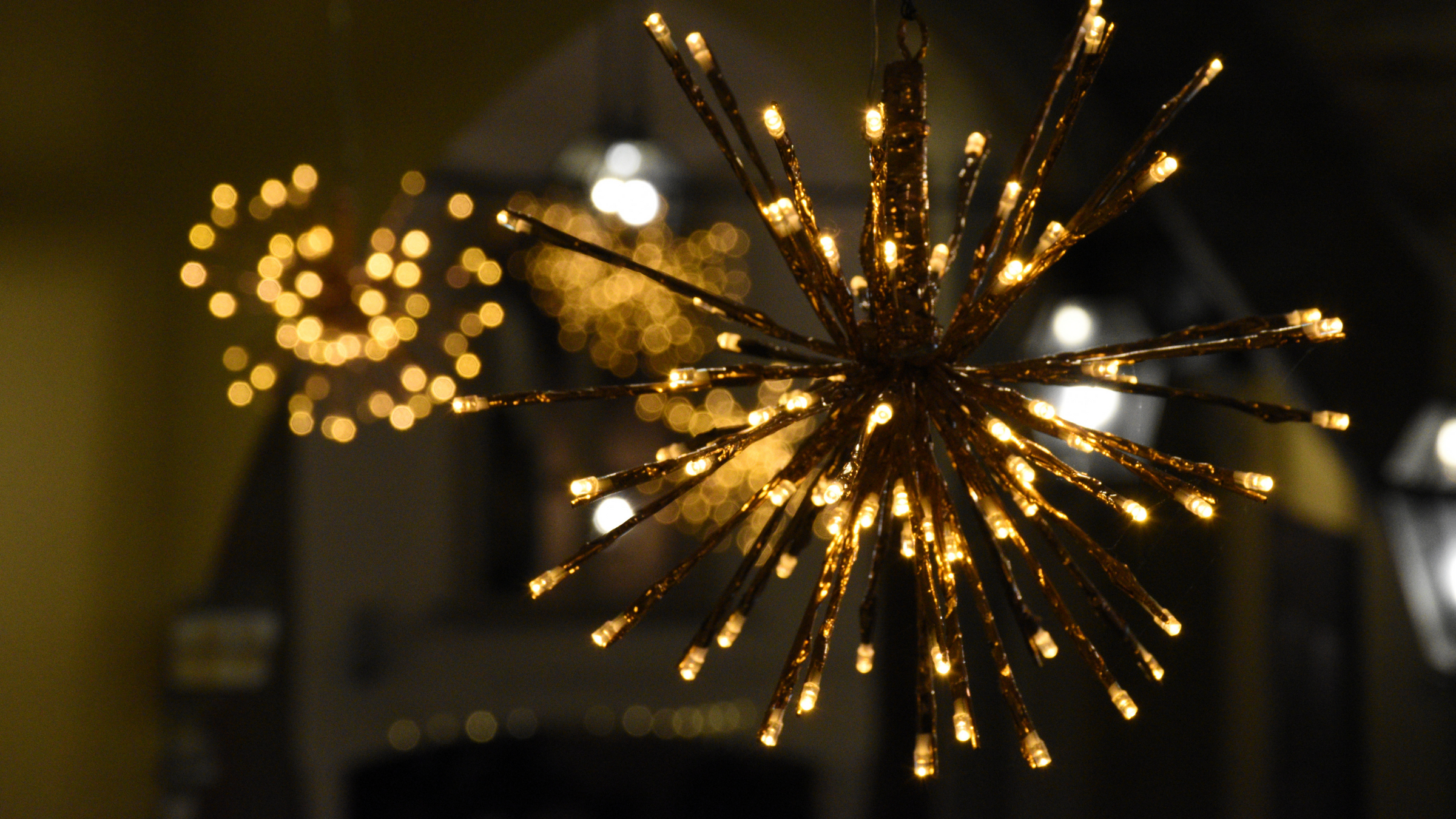 pre-light twig tree ball decoration hanging outside in garden