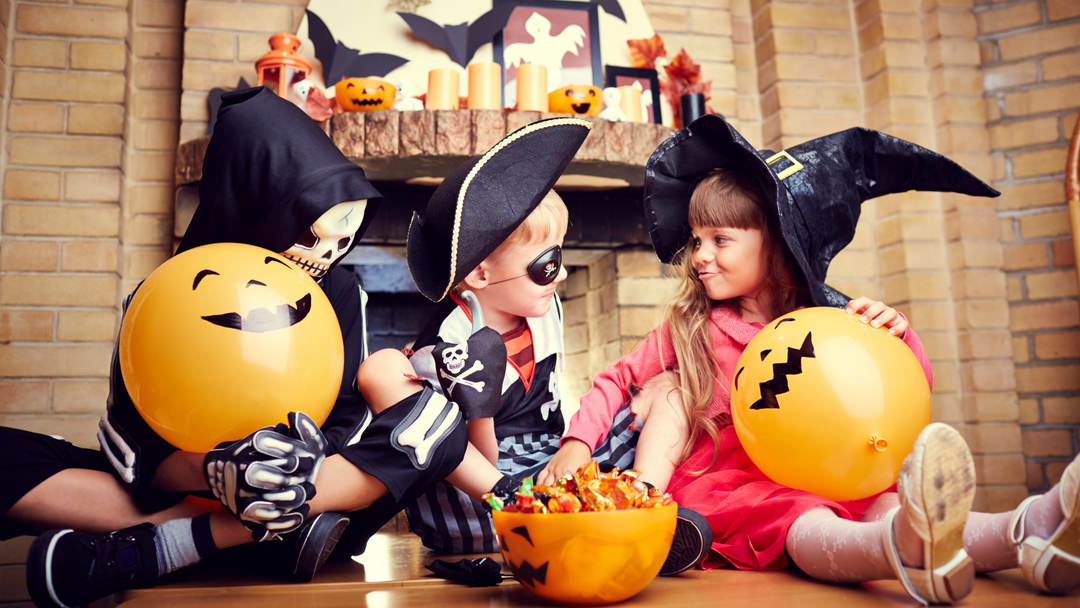 kids at halloween dressed up and eating candy