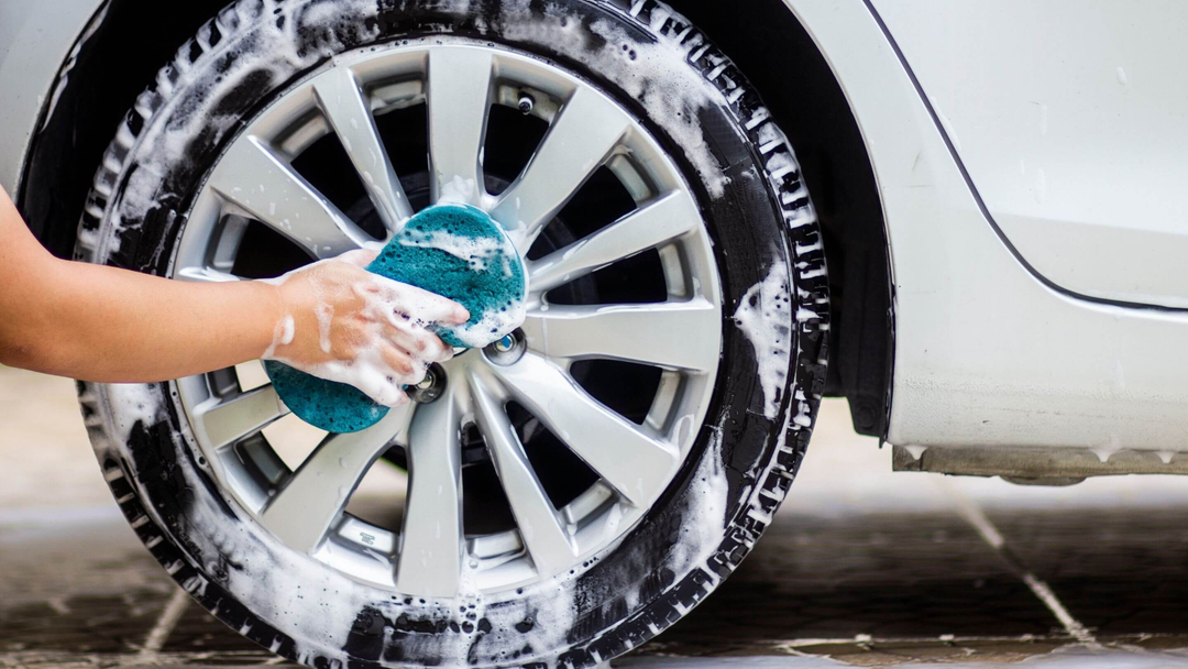 car wheeltrim being cleaned with soapy water and sponge