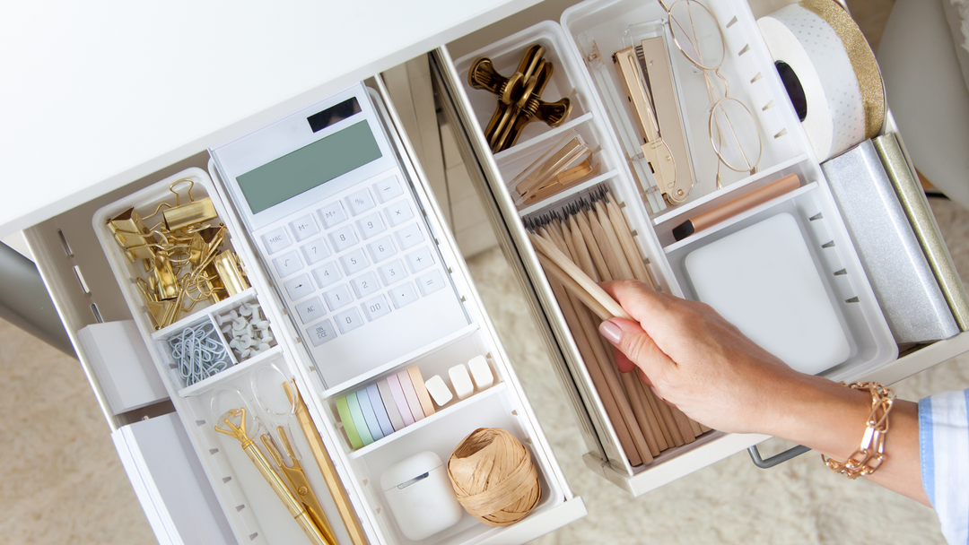 colour pencils, scissors and paper clips on white background