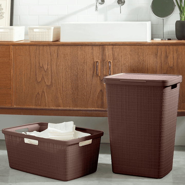 laundry hamper and laundry basked in bathroom in front of wooden storage cabinet and bathroom sink