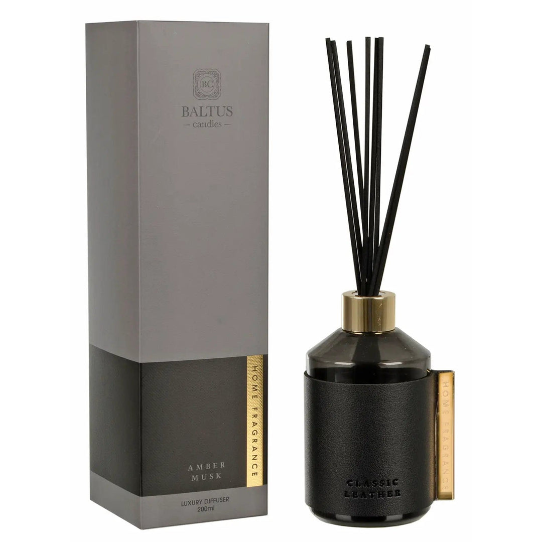 Amber Musk Classic Leather reed diffuser with gold tone clip and top, black reeds and box packaging