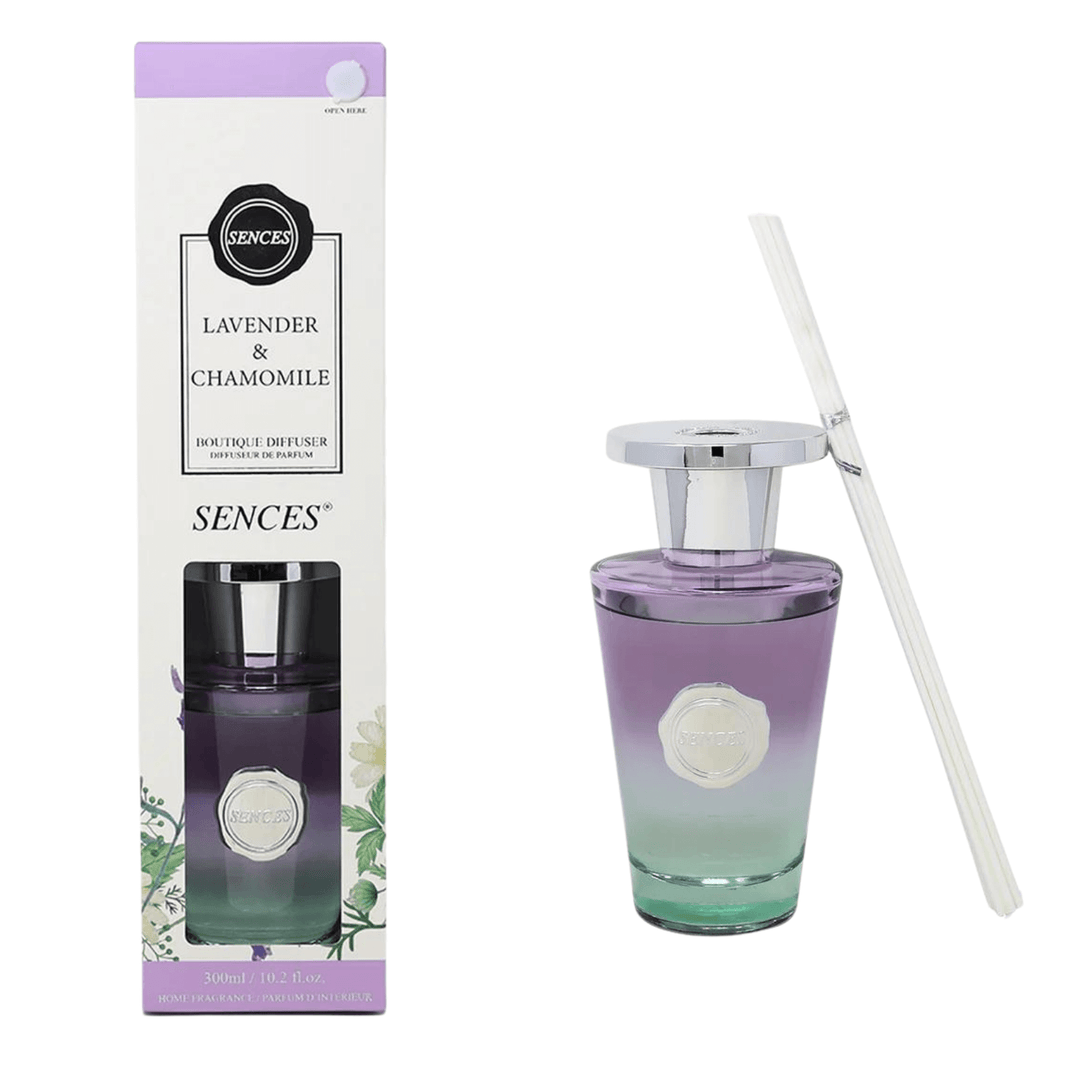 lavendar & chamomile reed difusser box packaging beside purple and green ombre coloured diffuser bottle with white reeds