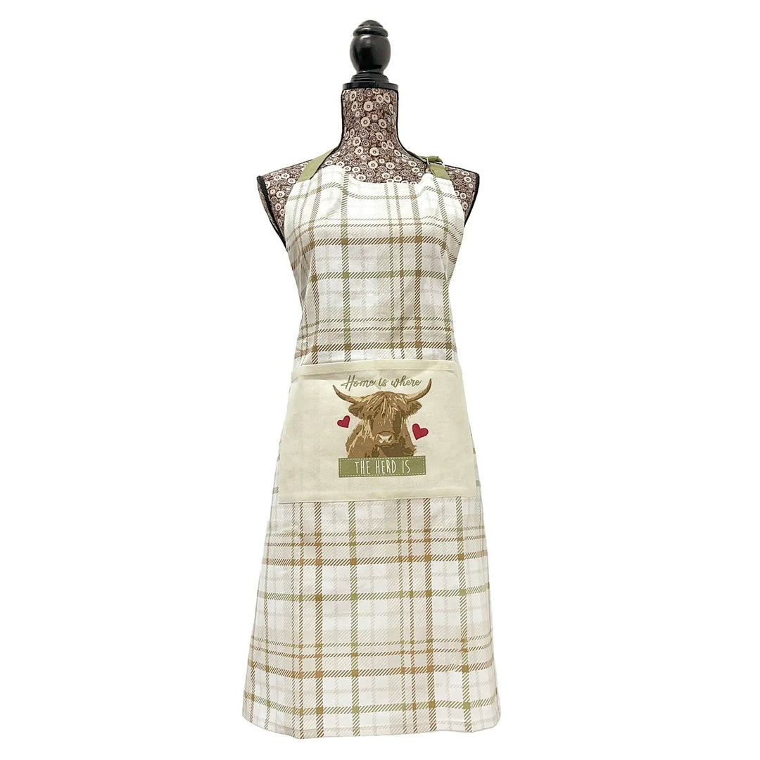 Chef's apron with overall white, green and brown tartan, and a highland cow print pocket with home is where the herd is text