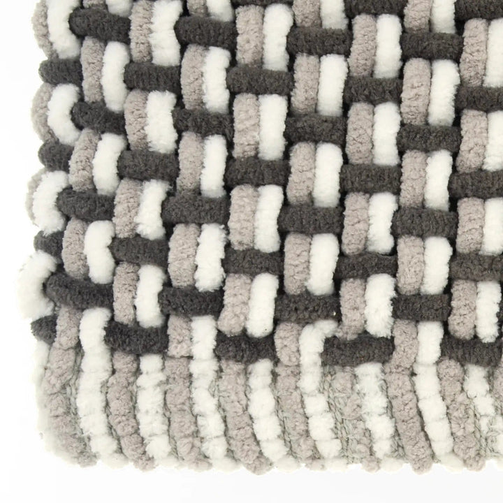 Close up of chunky woven fibres on a bath mat in monochrome colours