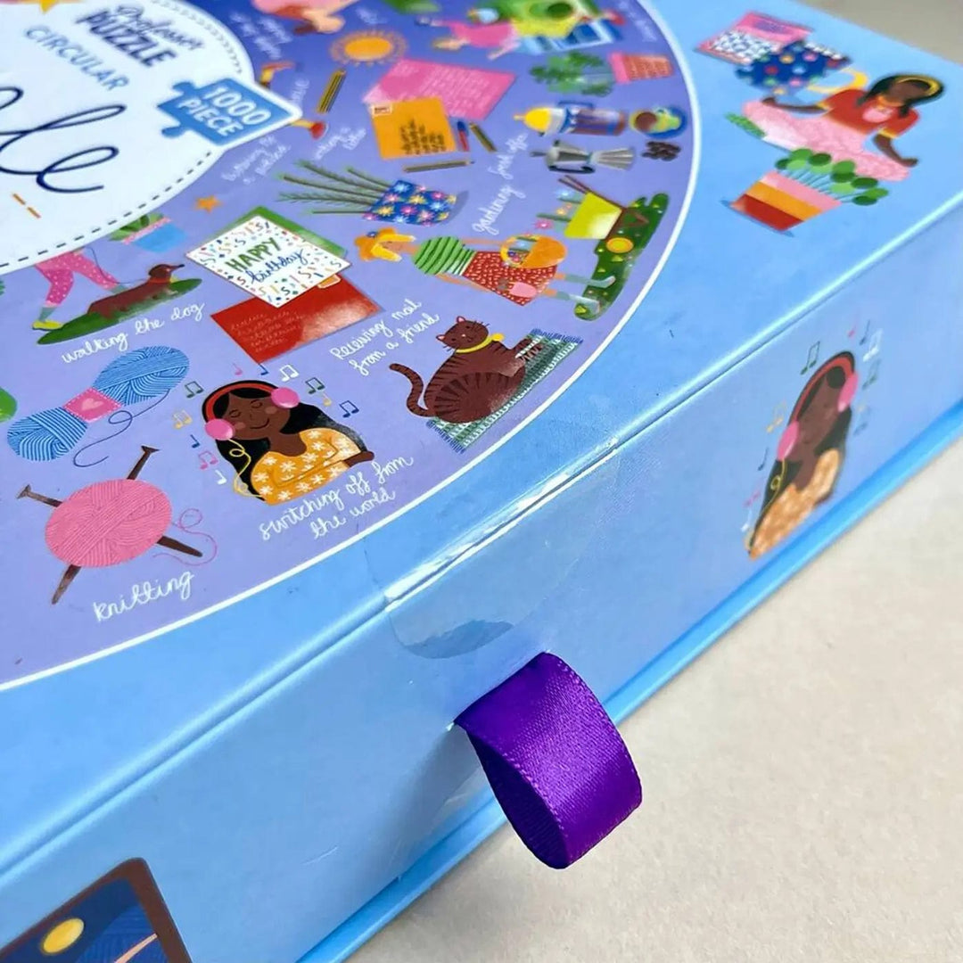 purple ribbon tab on the box of Simple Joys circle jigsaw puzzle