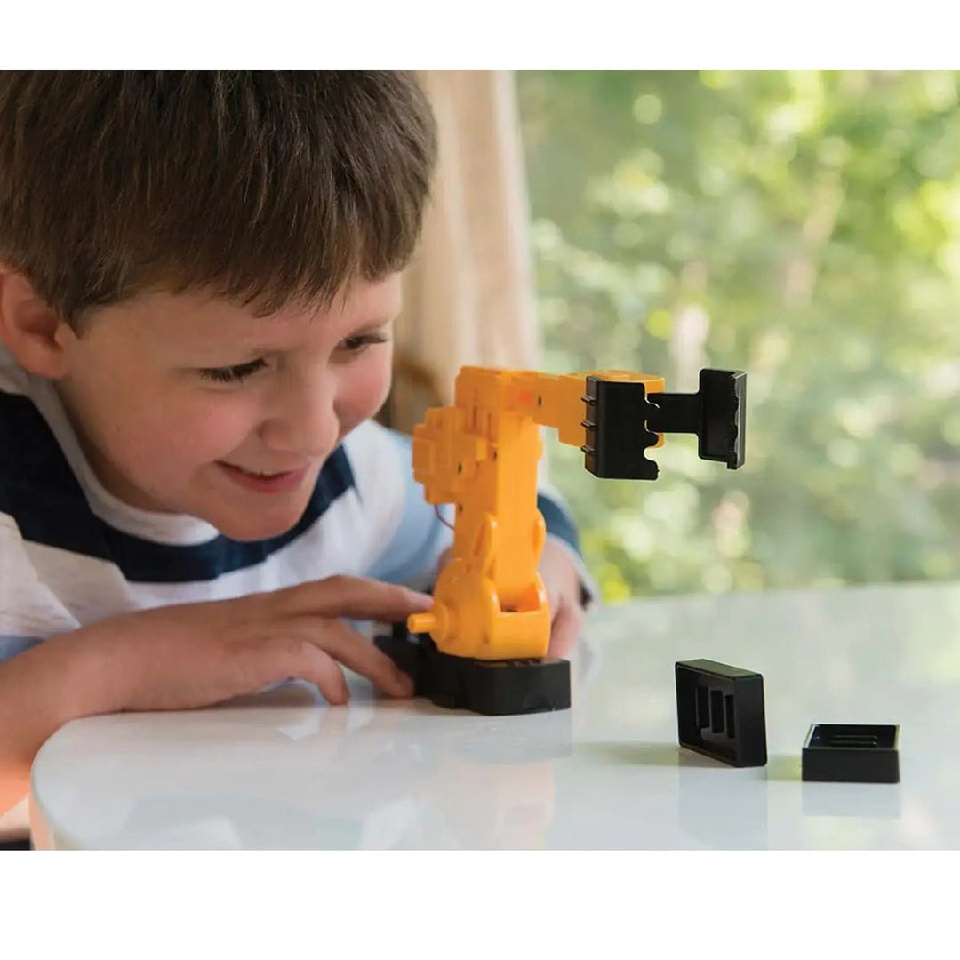 Child playing with a motorised robotic arm for fun play