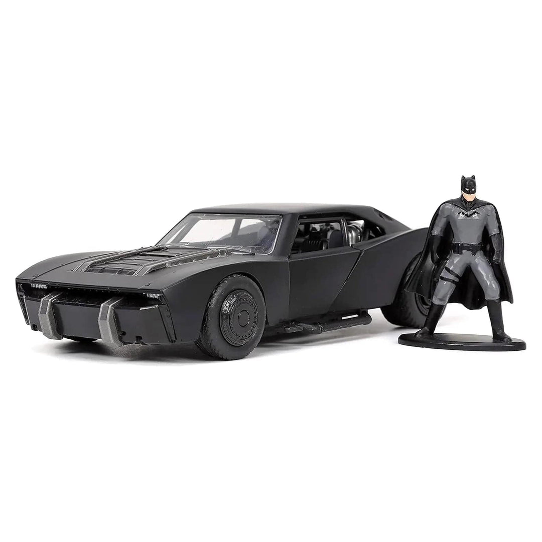 Batman figure standing beside  a black batmobile die-cast car