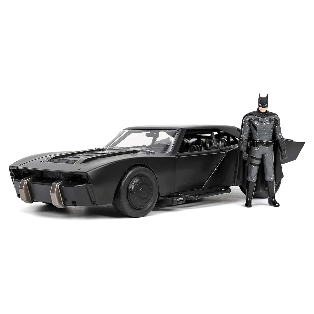 Batman figure standing beside a black Batmobile car