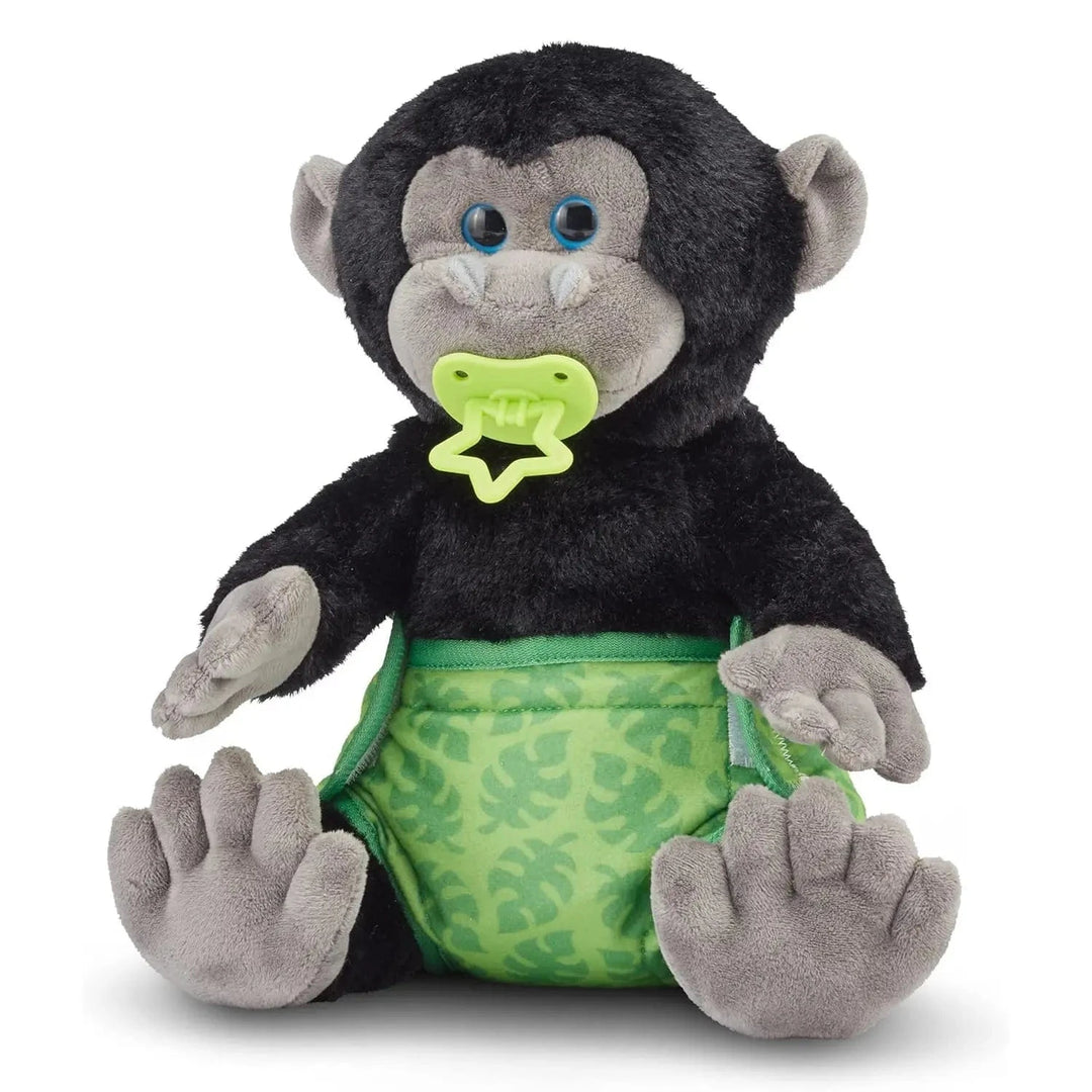 Baby gorilla soft toy animal with pacifier in its mouth, and wearing a green nappy