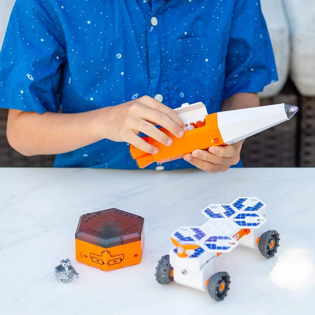 Child building a rocket with a circuit explorer construction kit