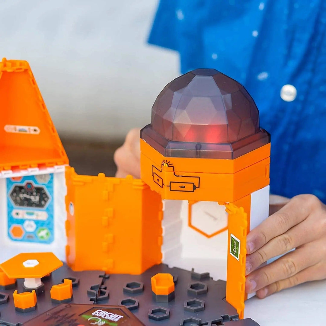 Child playing with Circuit Explorer Deluxe Base Station building set