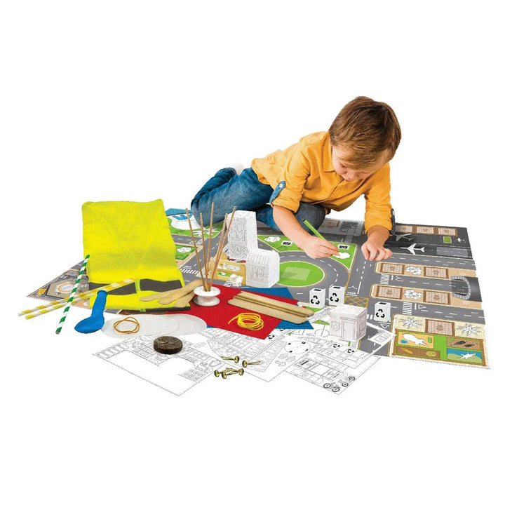 Child playing on the floor building a city with giant floor plan