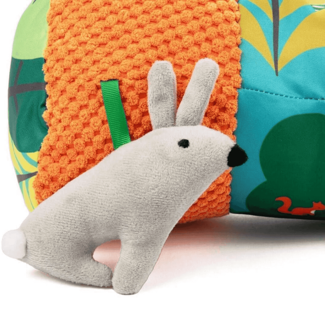 detail shot of bunny rabbit soft toy on tummy time roller pillow.