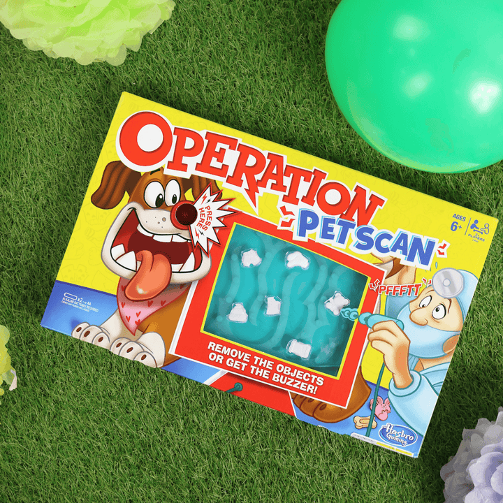 operation pet scan board game on grass with colourful balloons and decorations