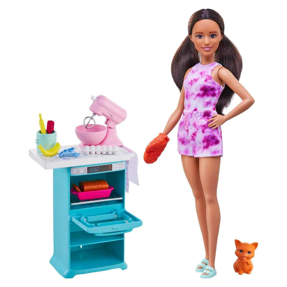 Barbie doll standing beside an oven with opening door and a pink food mixer, with kitten by her feet