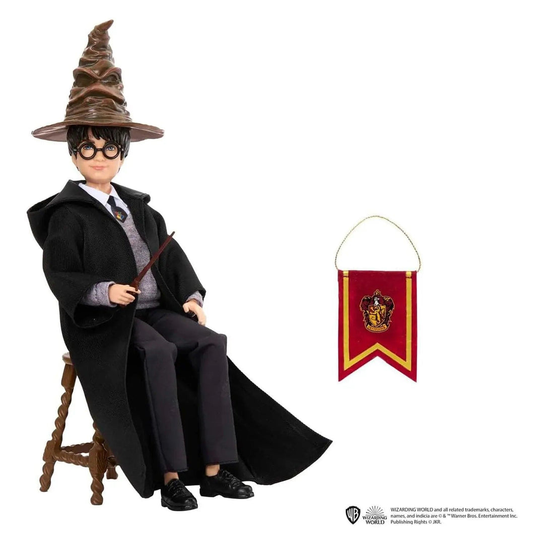 Harry Potter doll wearing the sorting hat, black cloak, holding a wand and sitting on a stool