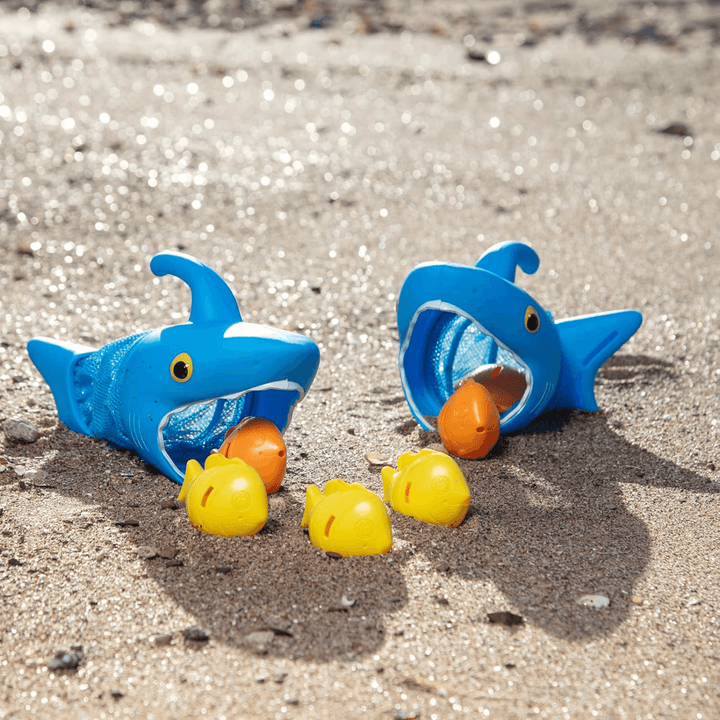 shark nets and fish sinkers on sand at beach