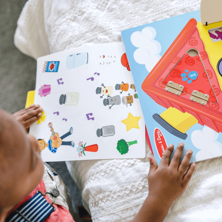 little boy slides storytelling card into activity wooden board at the top