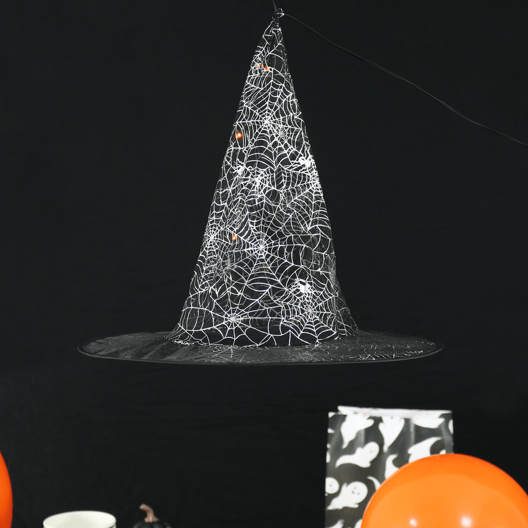 detail shot of witches hat floating decoration with orange led lights inside, finished with silver web detail