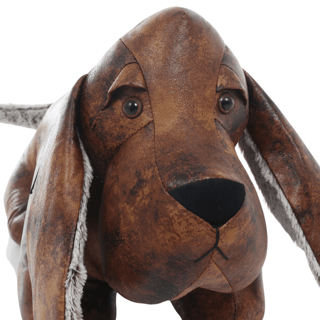 detail shot of sausage dog face featuring beaded eyes, plush nose and faux leather materials