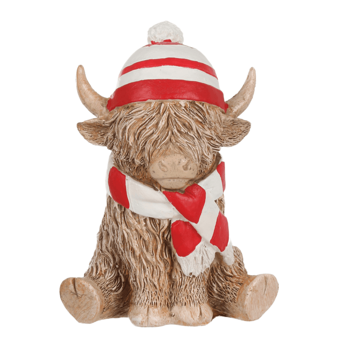 small highland cow ornament wearing red and white striped hat and scarf