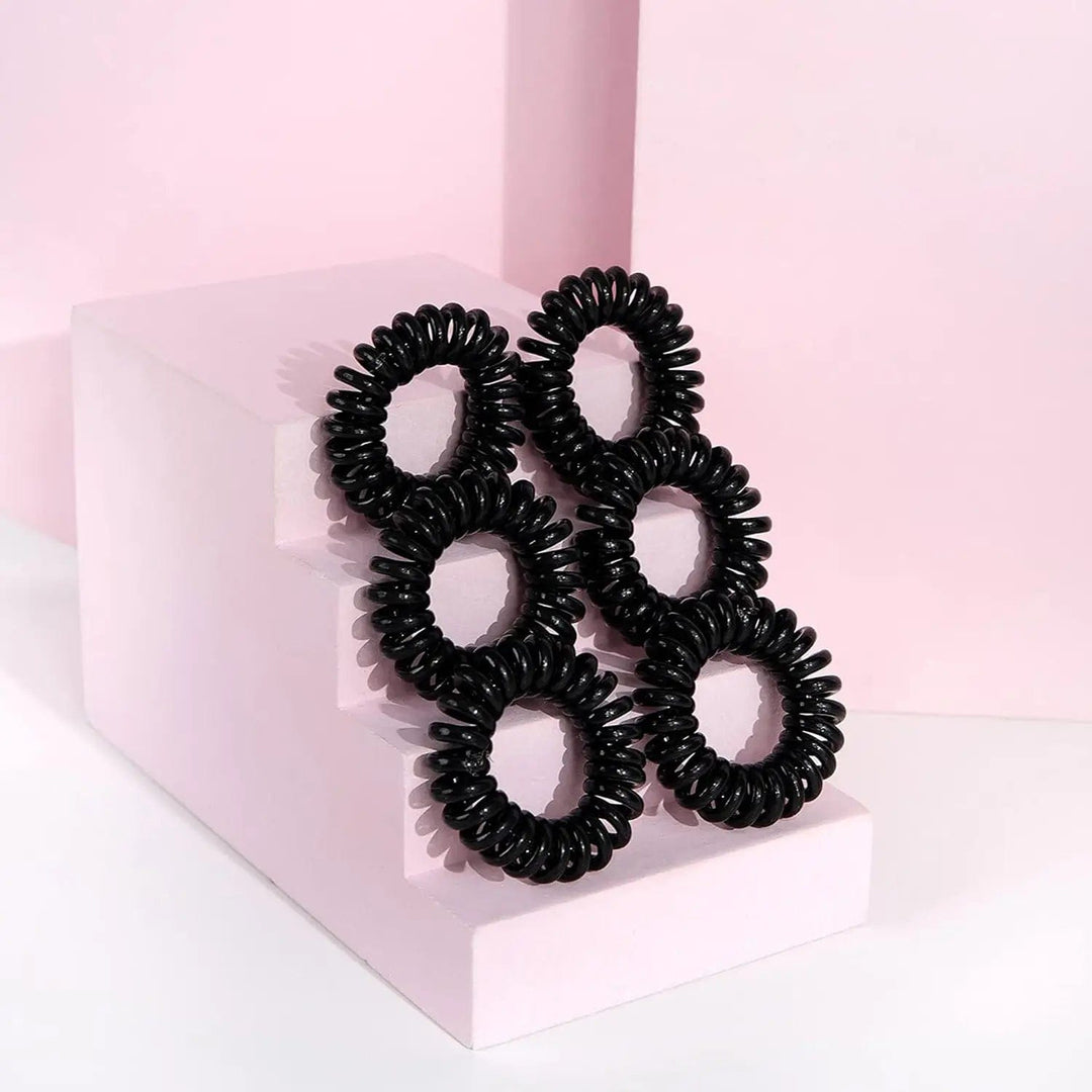 6 black spiral hair bobbles on a pick display unit