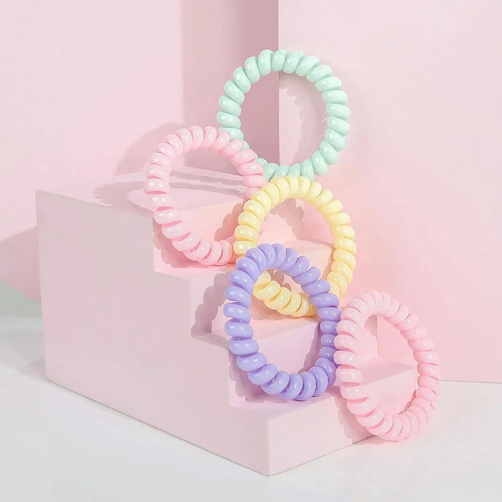 5 pastel colour spiral hair bobbles on a pink display step unit