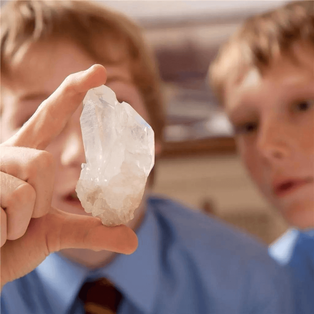 two young boys inspecting created white crystal