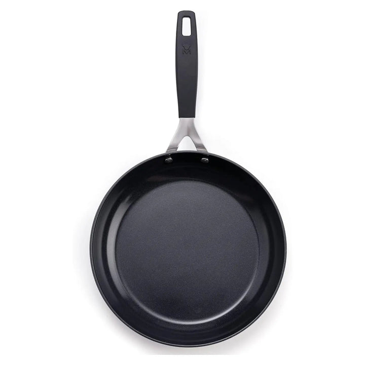 Overhead view of a 12cm black non-stick frying pan