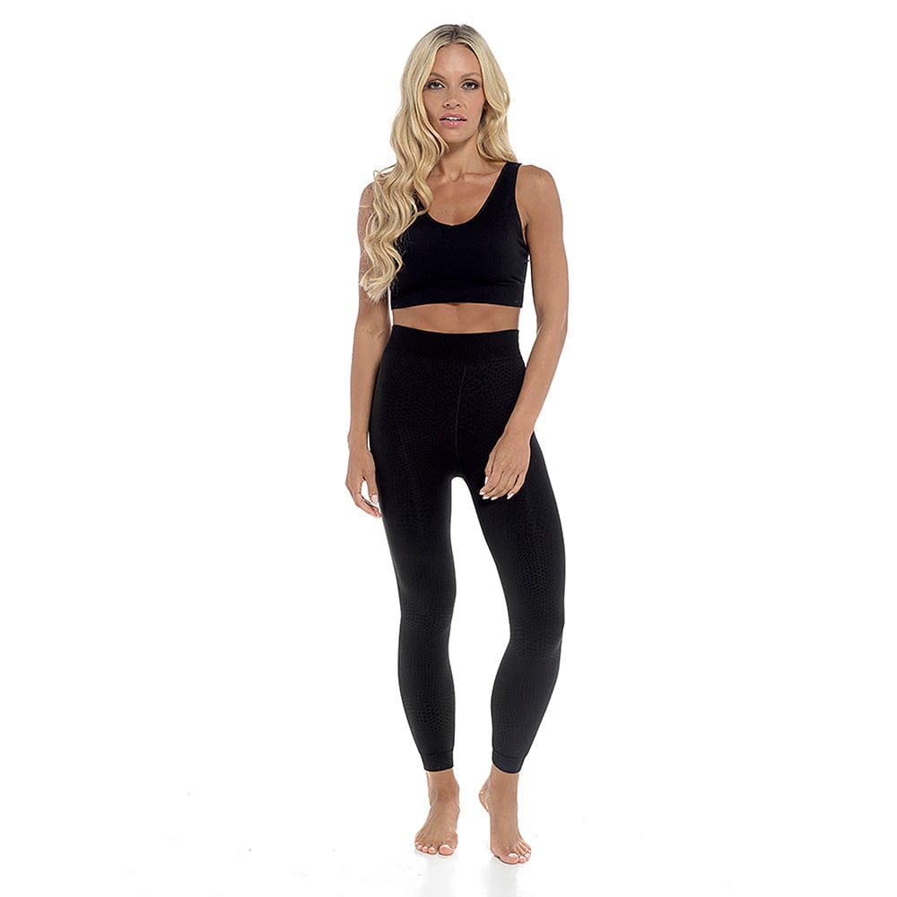 women wearing snakeskin leggings with black crop top
