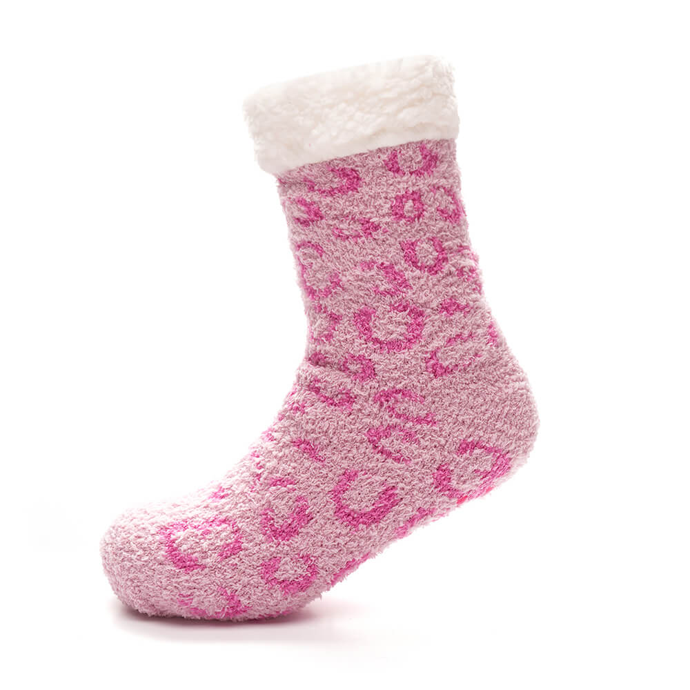 pink animal print lounge socks with sherpa trim on foot with grippers on the base