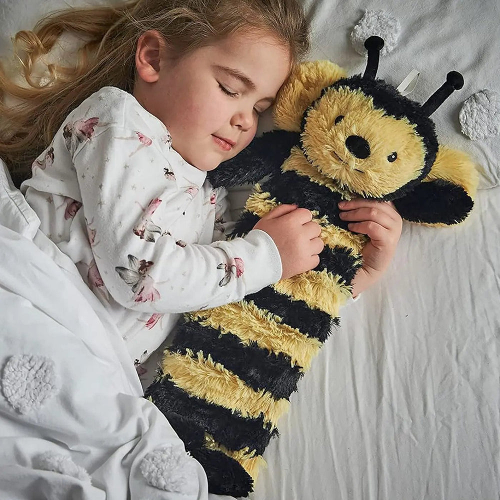 Child in pyjamas, in bed cuddling a bumblebee design long hot water bottle