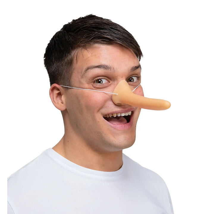 Man wearing a fake long nose for Pinocchio fancy dress costumes