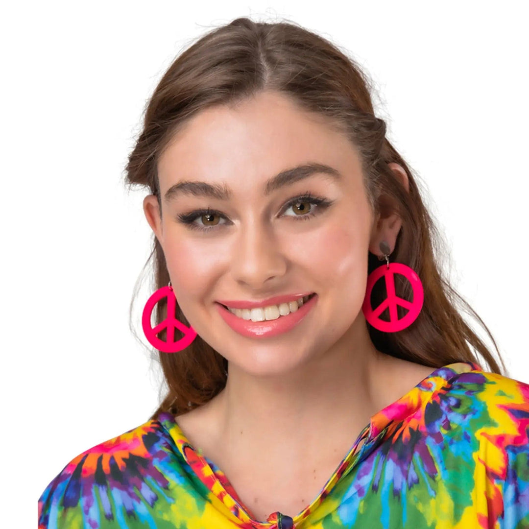 Lady wearing a pair of bright neon pink CND peace hippie earrings for 60s and 70s fancy dress costumes