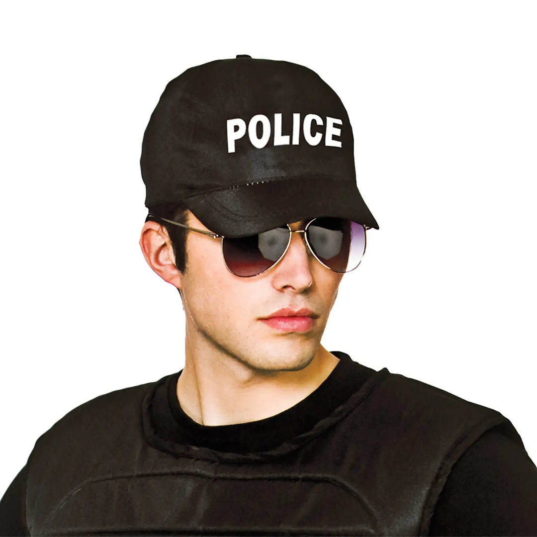 Man wearing black top, sunglasses and a black baseball cap with the word POLICE on the front