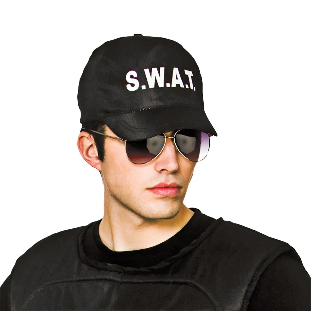 Man wearing sunglasses and a black baseball cap with SWAT lettering on the front