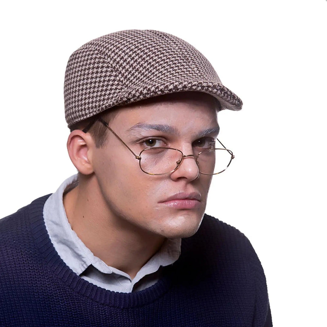 Man wearing glasses and a tweed cap for fancy dress costumes