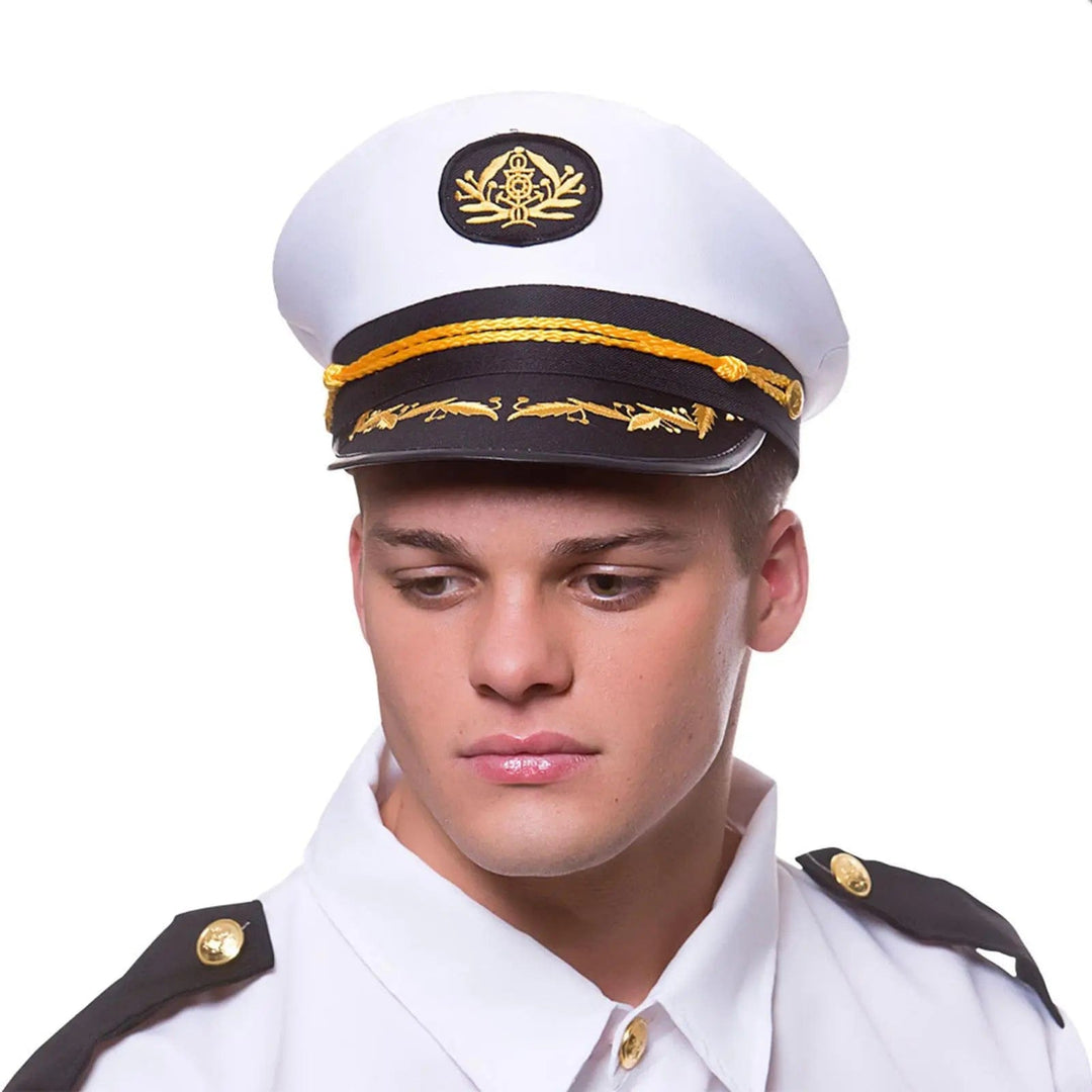 Man wearing a classic ship's captain hat in white and black woth gold braid detailing for fancy dress uniforms parties