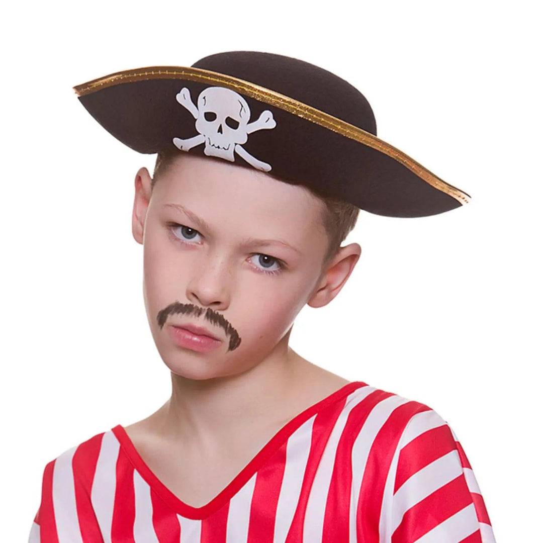 Boy wearing a red striped shirt and a black pirate hat with skull and crossbones for fancy dress parties