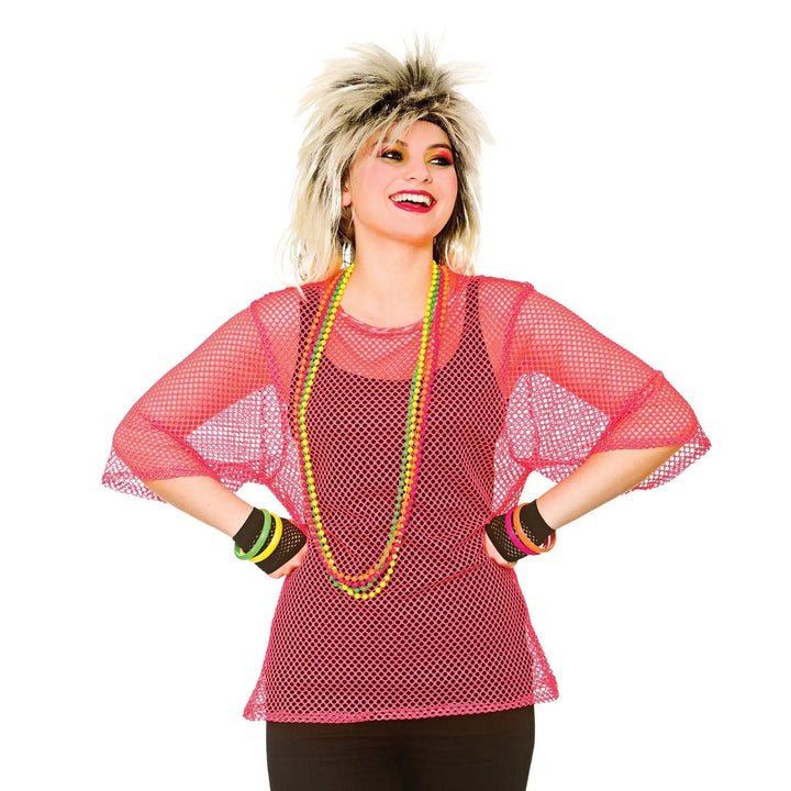 Woman wearing a neon pink mesh top with 1980s punk style wig for fancy dress parties