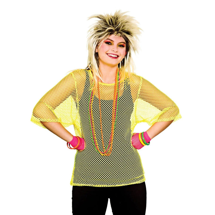 Young woman wearing a bright neon yellow mesh top with 1980s punk style wig for fancy dress parties